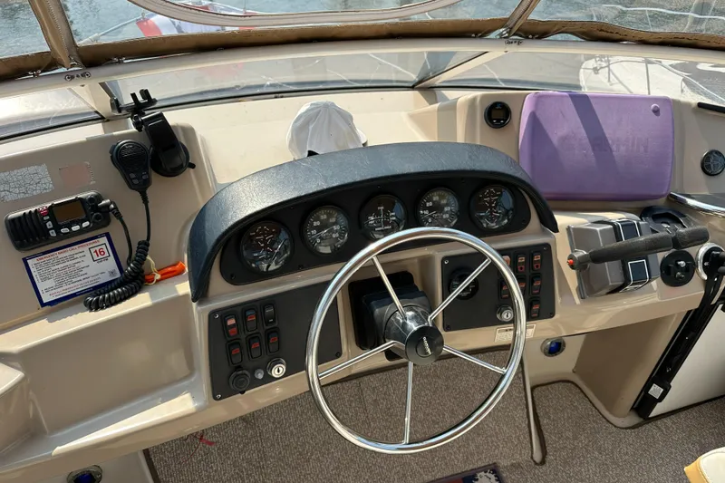 Slide: The Image of 2005 Carver 366 Motor Yacht helm with steering wheel and control panel. - 13