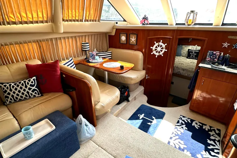 Slide: The Image of Interior of 2005 Carver 366 Motor Yacht with cozy seating and nautical decor. - 20