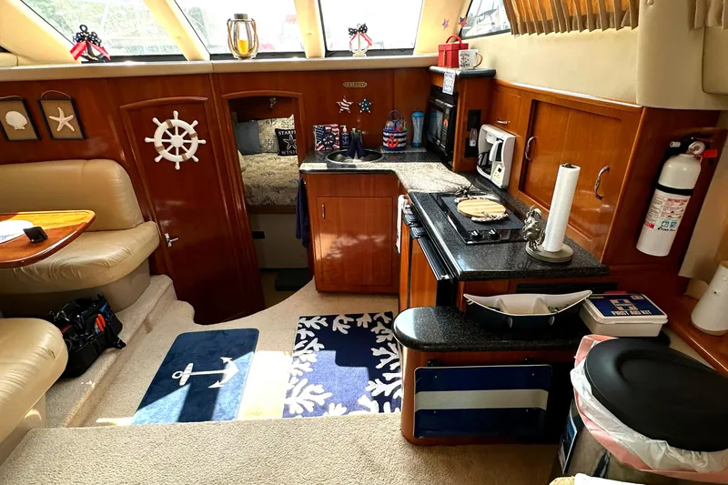 Slide: The Image of Interior of 2005 Carver 366 Motor Yacht with cozy kitchen and seating area. - 21