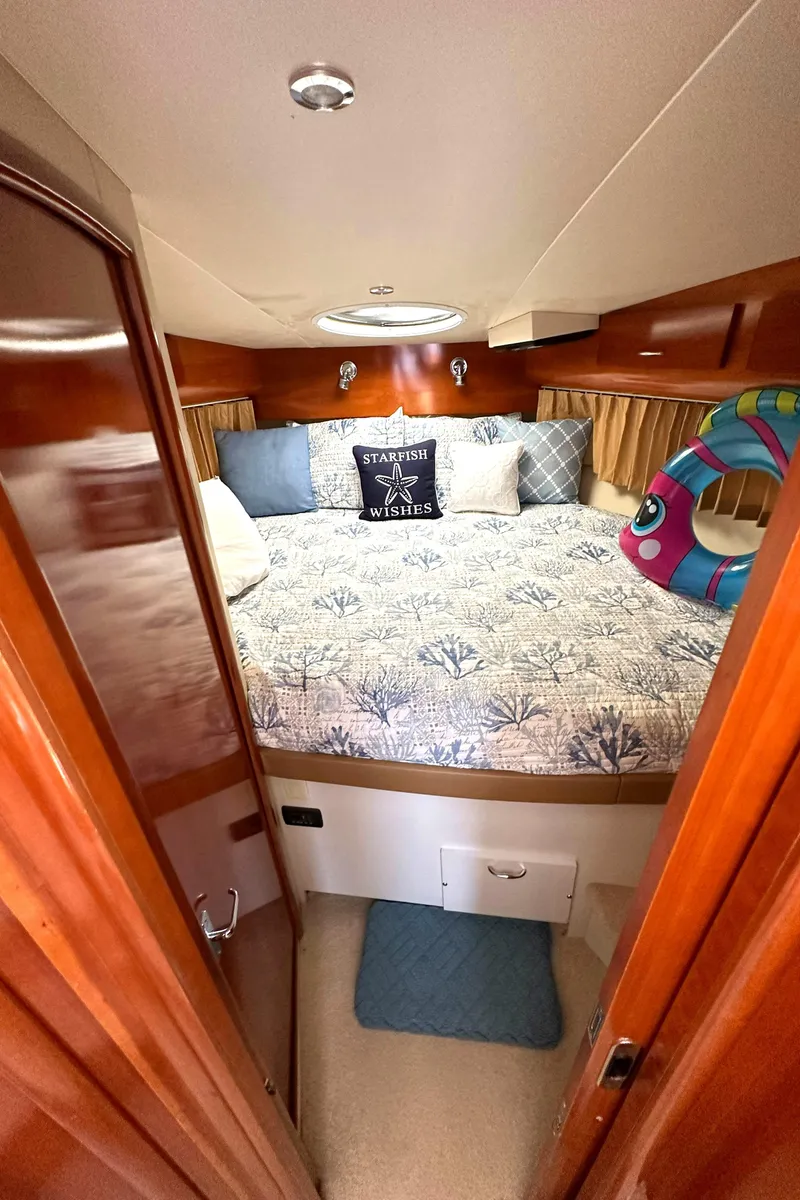 Slide: The Image of Cozy bedroom in 2005 Carver 366 Motor Yacht with nautical decor and plush bedding. - 23