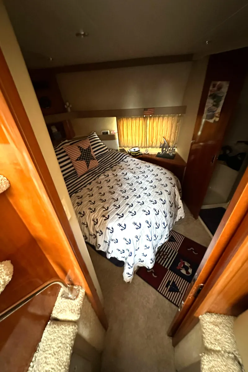 Slide: The Image of Cozy bedroom in 2005 Carver 366 Motor Yacht with nautical-themed bedding. - 24