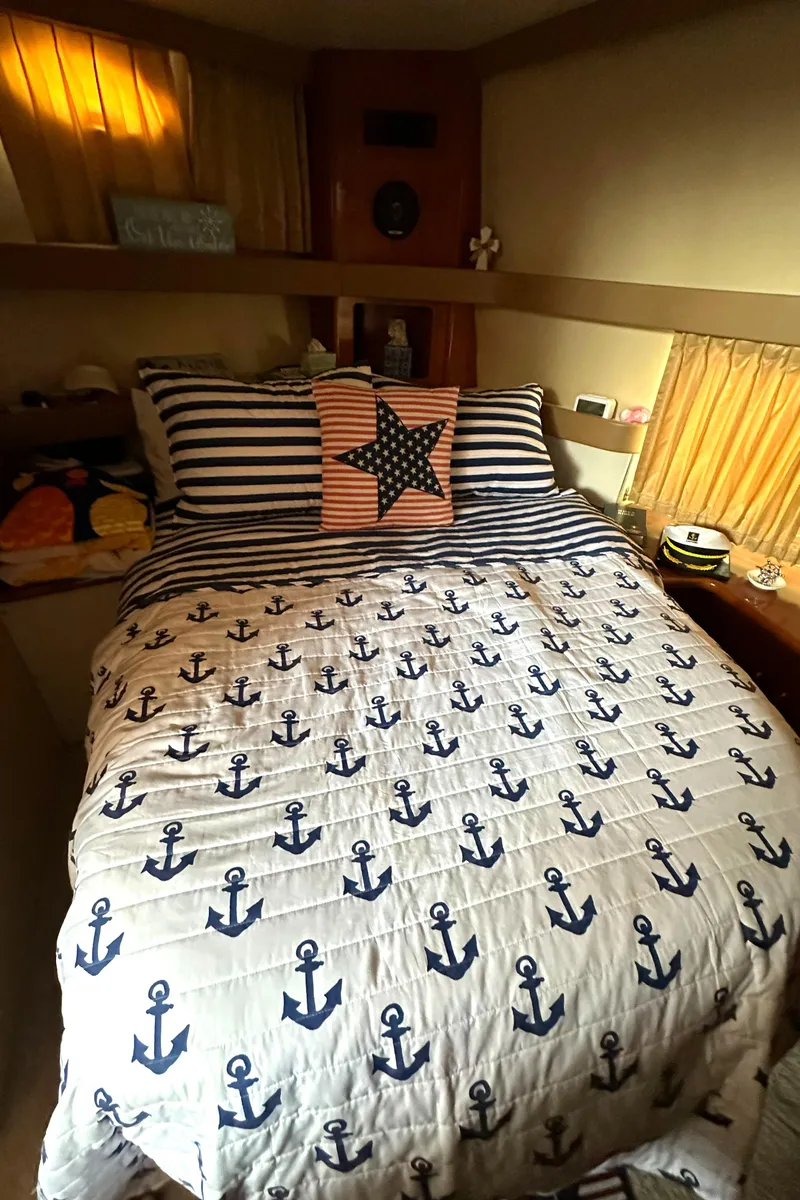 Slide: The Image of Cozy bedroom in 2005 Carver 366 Motor Yacht with nautical-themed bedding. - 27