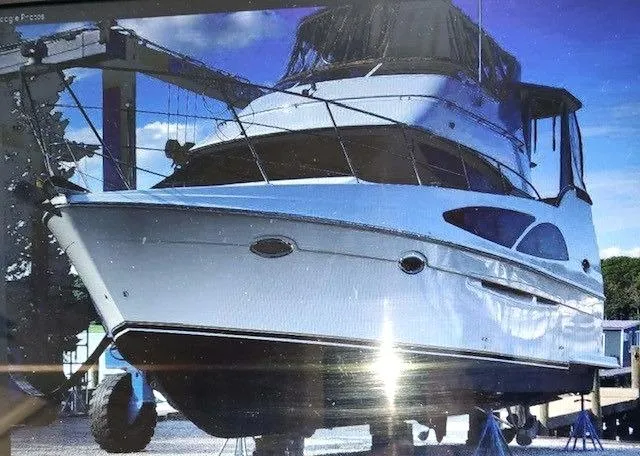 Slide: The Image of 2005 Carver 366 Motor Yacht on dry dock under clear blue sky. - 3