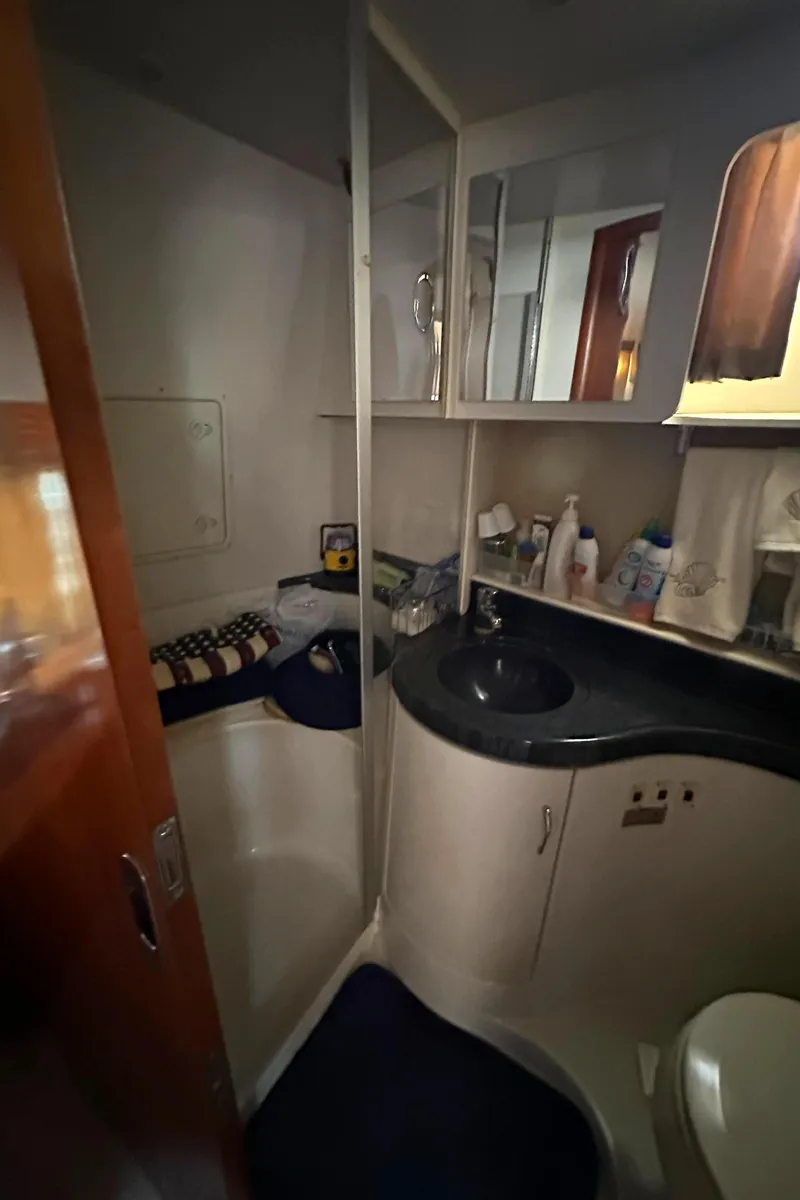 Slide: The Image of 2005 Carver 366 Motor Yacht bathroom with sink, mirror, and storage shelves. - 31