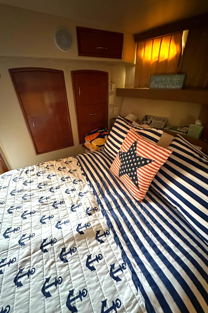 Slide: The Image of Cozy bedroom in 2005 Carver 366 Motor Yacht with nautical-themed bedding. - 32