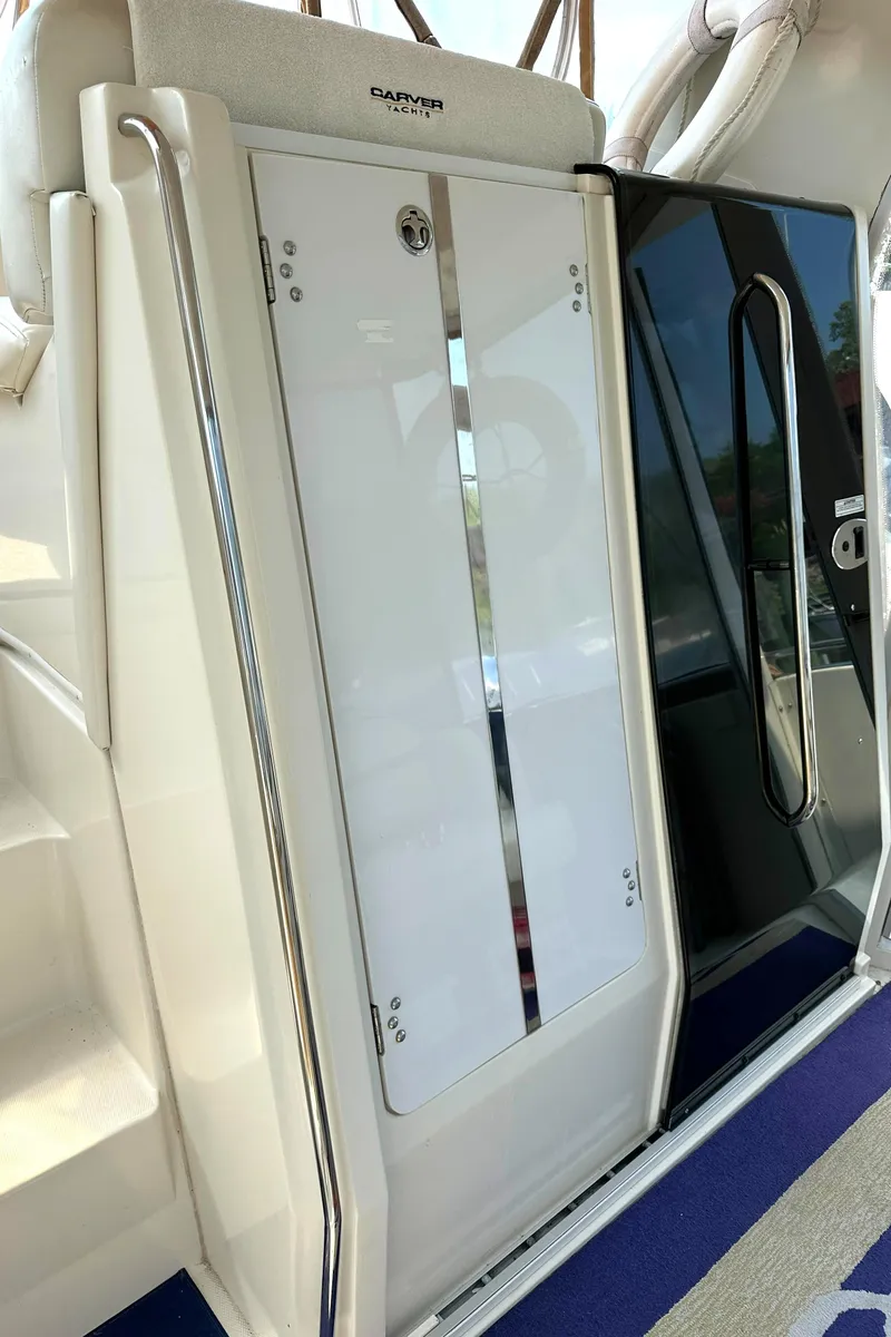 Slide: The Image of 2005 Carver 366 Motor Yacht entrance with sleek white and black door design. - 33