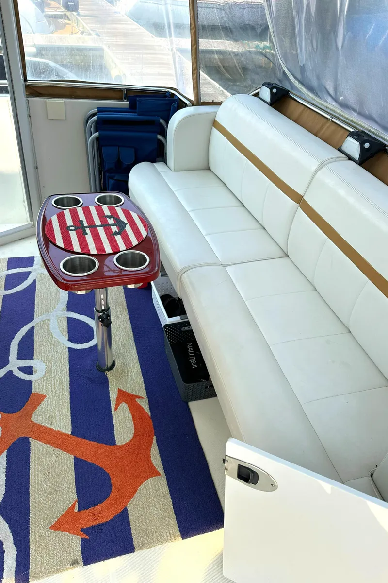 Slide: The Image of Interior of 2005 Carver 366 Motor Yacht with white seating and nautical-themed decor. - 34