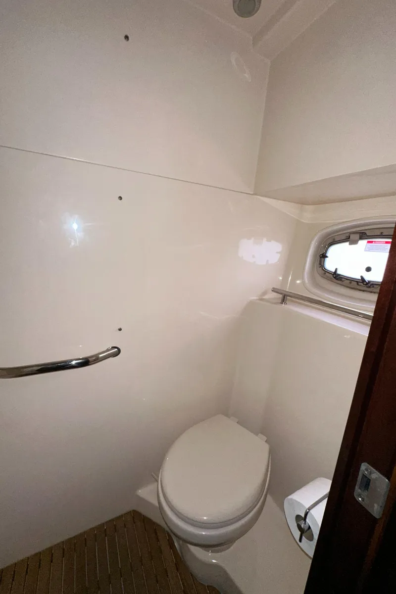 Slide: The Image of 2005 Carver 366 Motor Yacht bathroom with toilet and porthole window. - 39