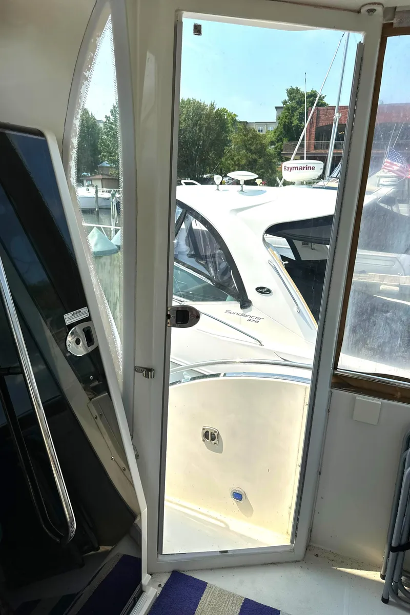 Slide: The Image of 2005 Carver 366 Motor Yacht interior view with open door, docked at marina. - 40