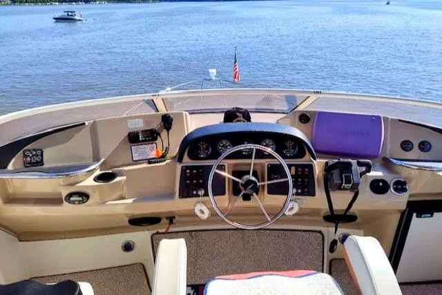 Slide: The Image of 2005 Carver 366 Motor Yacht helm with lake view and navigational controls. - 43