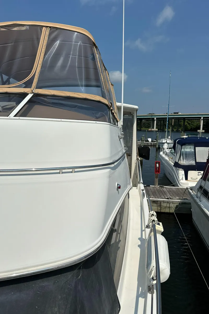 Slide: The Image of 2005 Carver 366 Motor Yacht docked at marina under clear blue sky. - 7