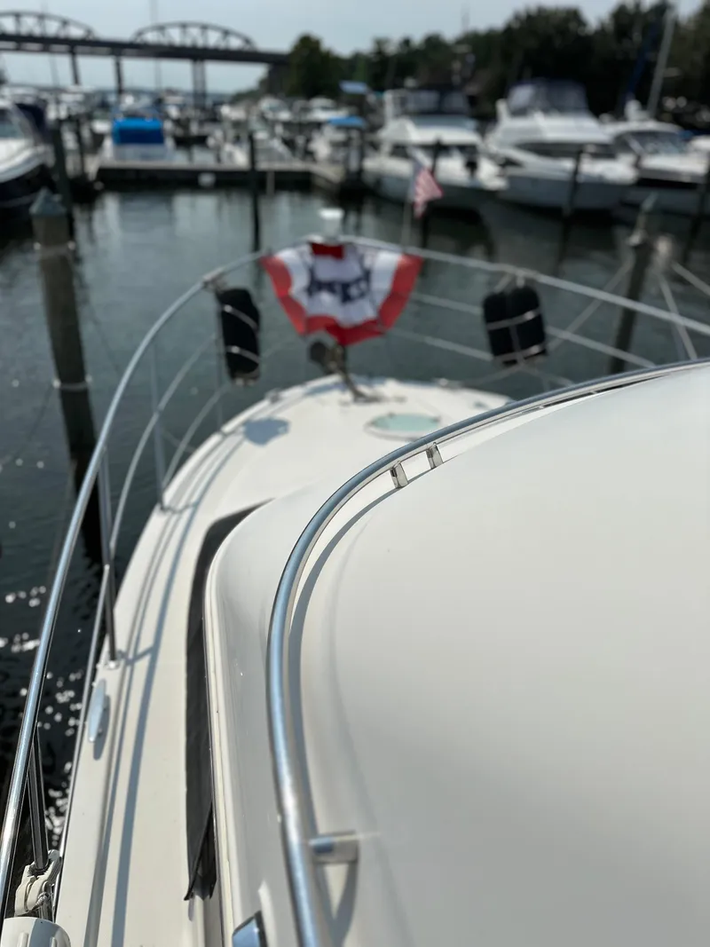 Slide: The Image of 2005 Carver 366 Motor Yacht docked at marina with festive decor. - 9