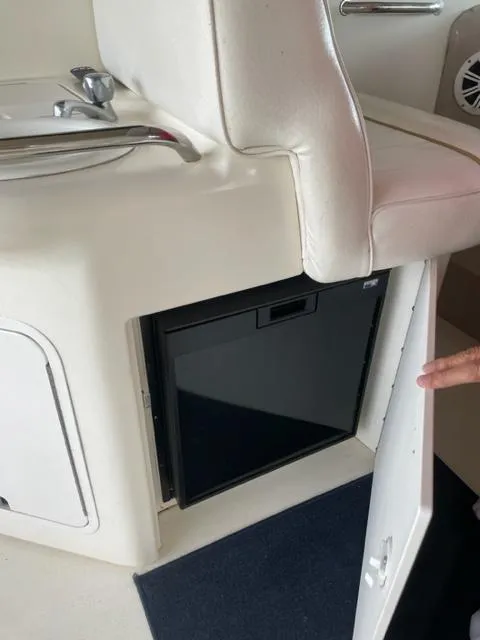 Slide: The Image of 1999 Sea Ray 330 Sundancer cabin with cozy bed and striped pillows. - 10