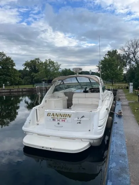 Slide: The Image of 1999 Sea Ray 330 Sundancer docked on a calm waterway. - 2