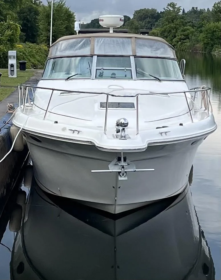 Slide: The Image of 1999 Sea Ray 330 Sundancer docked on calm water. - 3