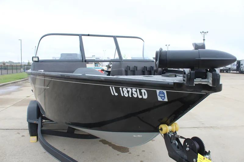 Slide: The Image of 2023 Tracker PG 175 WT SW boat on trailer, black exterior, parked outdoors. - 4