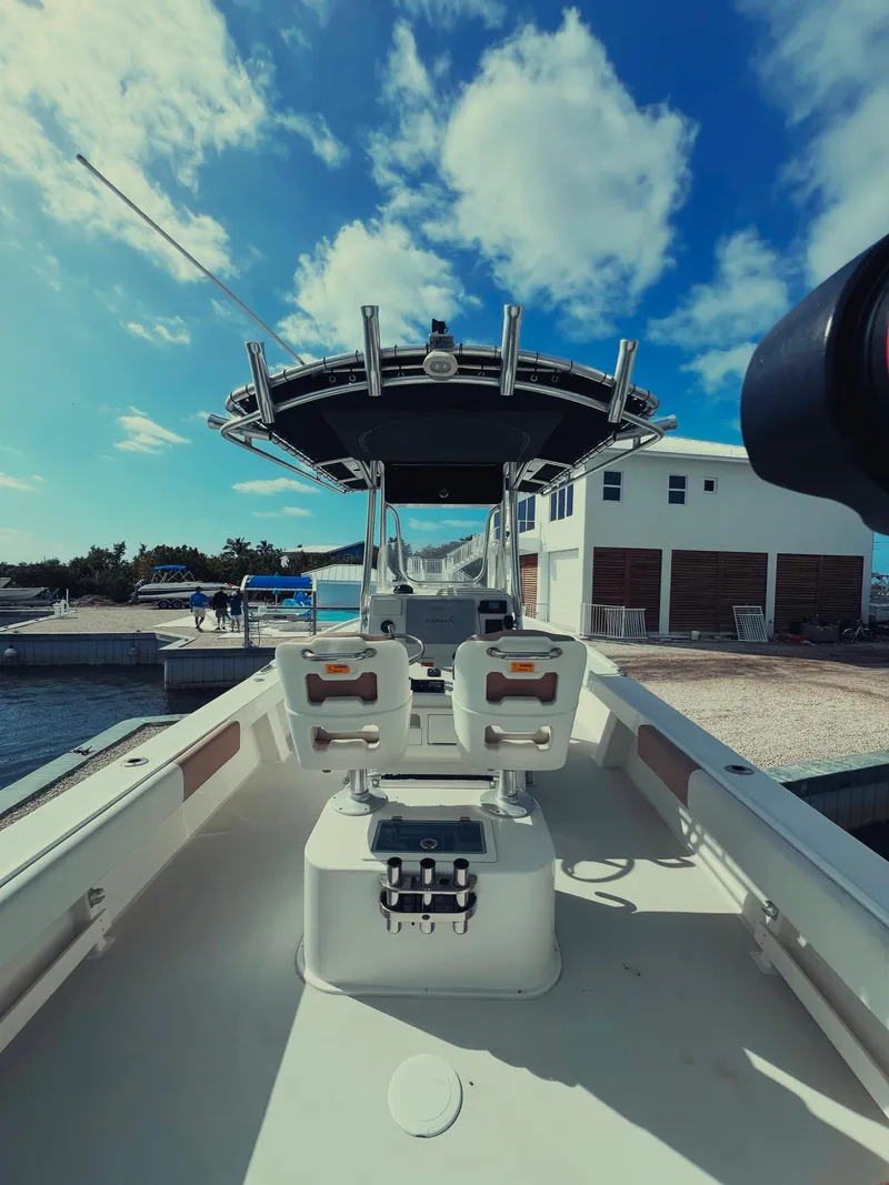 Slide: The Image of 2017 Parker 2801 Center Console boat docked under a clear blue sky. - 20
