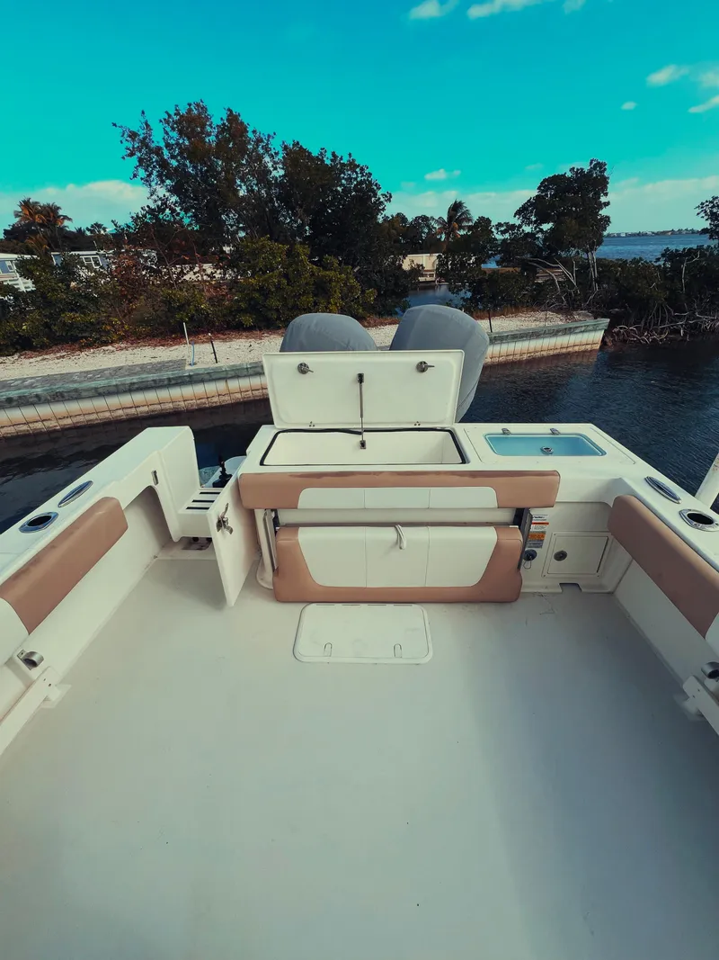 Slide: The Image of 2017 Parker 2801 Center Console boat with dual engines, docked by a scenic waterfront. - 24