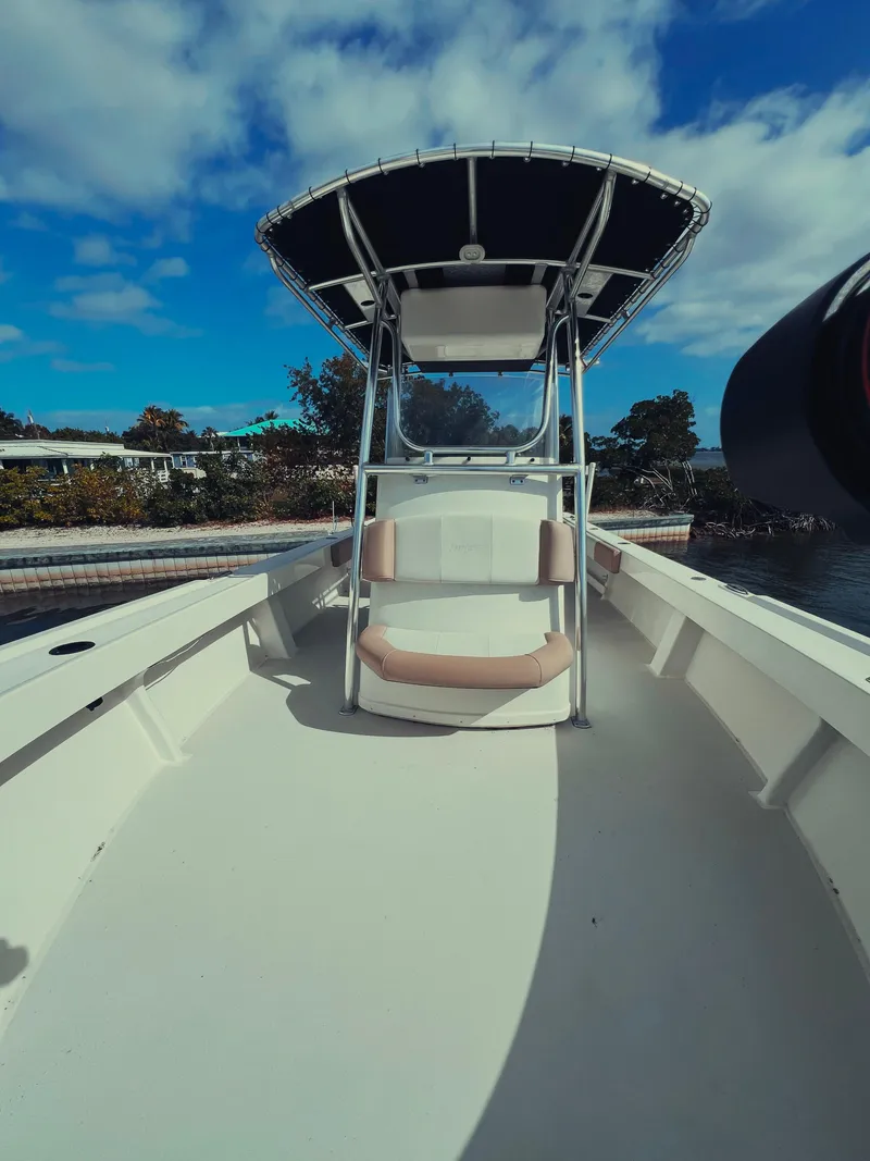 Slide: The Image of 2017 Parker 2801 Center Console boat with T-top, docked under a blue sky. - 29