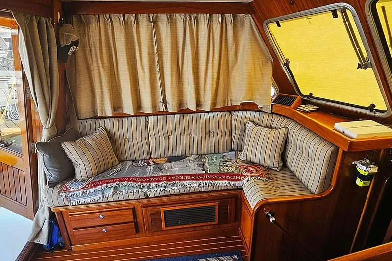 Slide: The Image of Cozy interior of 2003 Menorquin 120 yacht with striped cushions and wooden accents. - 13