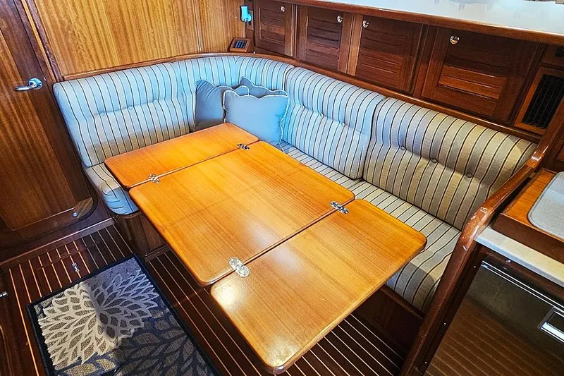 Slide: The Image of Cozy dining area in 2003 Menorquin 120 yacht with striped upholstery and wooden table. - 15
