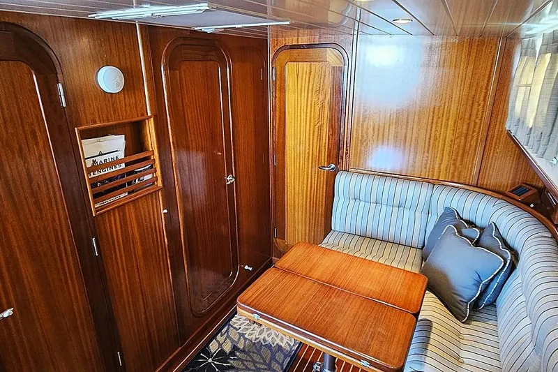 Slide: The Image of Interior of 2003 Menorquin 120 yacht with wooden paneling and striped seating. - 16