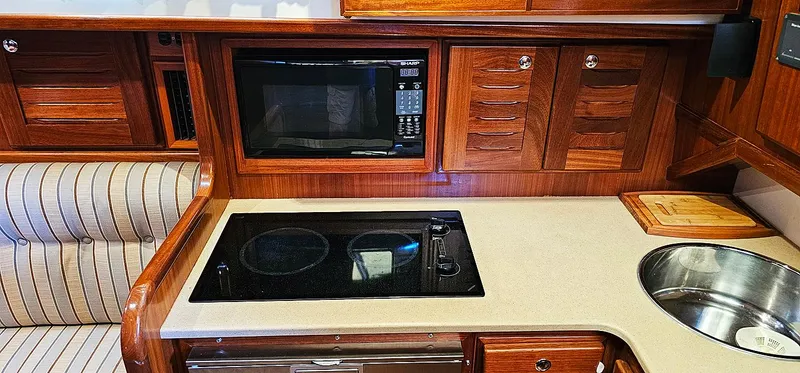 Slide: The Image of Menorquin 120 yacht kitchen area, 2003 model, featuring stove and microwave. - 18