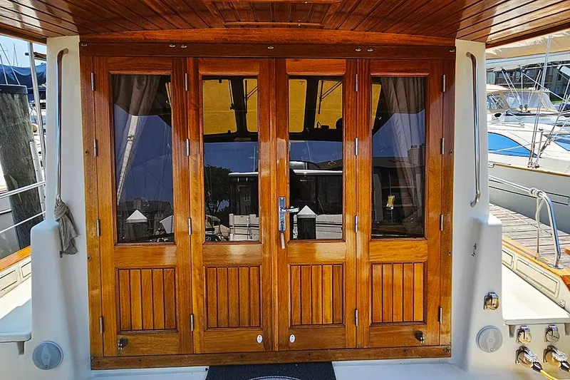 Slide: The Image of Wooden doors on a 2003 Menorquin 120 yacht, docked at a marina. - 3
