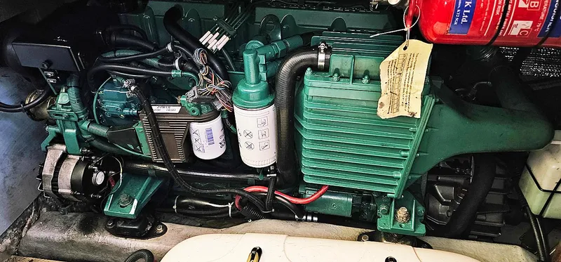 Slide: The Image of Engine compartment of a 2003 Menorquin 120 with green engine cover. - 31