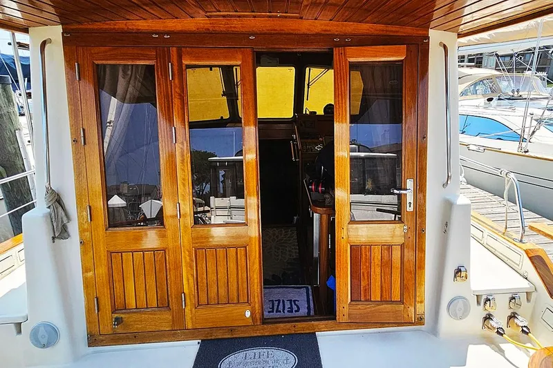 Slide: The Image of Wooden doors on a 2003 Menorquin 120 yacht, docked at a marina. - 4