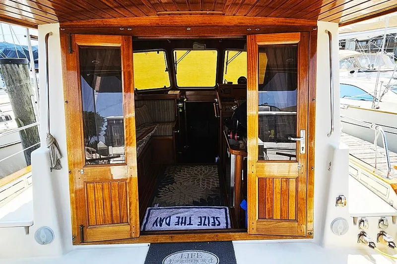 Slide: The Image of Wooden cabin doors of a 2003 Menorquin 120 boat, docked at a marina. - 5