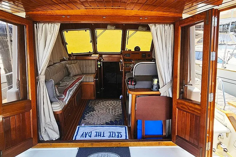 Slide: The Image of Interior of 2003 Menorquin 120 boat with wooden finish and cozy seating area. - 6