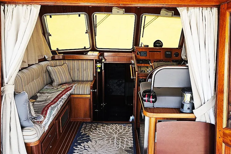 Slide: The Image of Interior of a 2003 Menorquin 120 boat with cozy seating and navigation area. - 7