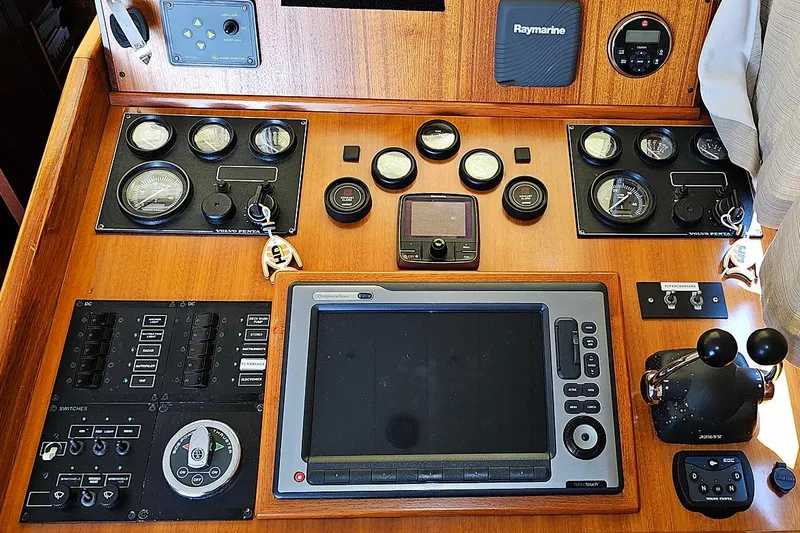 Slide: The Image of Control panel of a 2003 Menorquin 120 boat with navigation instruments and gauges. - 9
