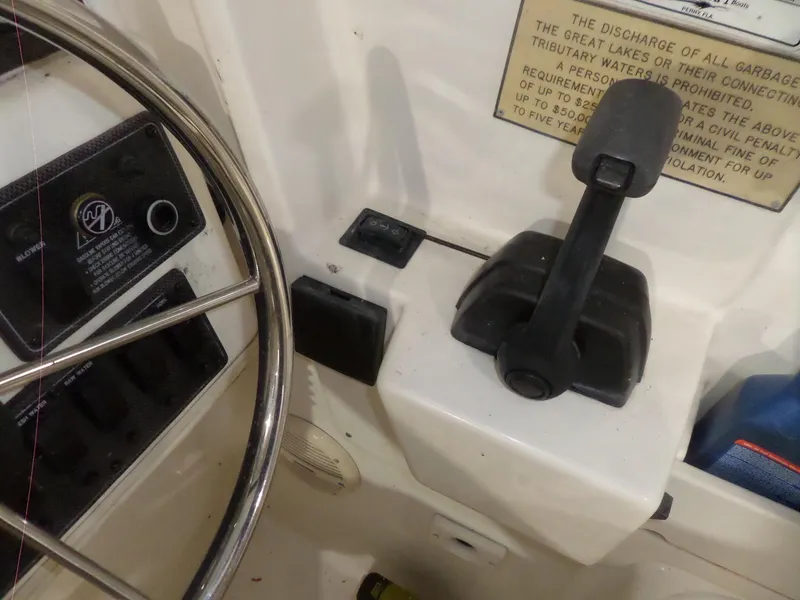 Slide: The Image of Close-up of 1999 Sport-Craft 251 WA boat controls and steering wheel. - 13