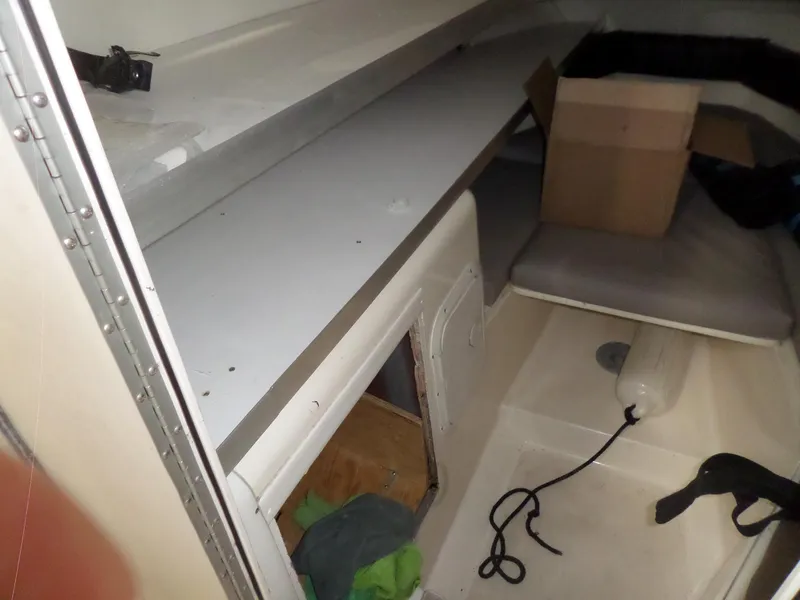 Slide: The Image of Interior cabin of 1999 Sport-Craft 251 WA boat with storage and seating. - 17