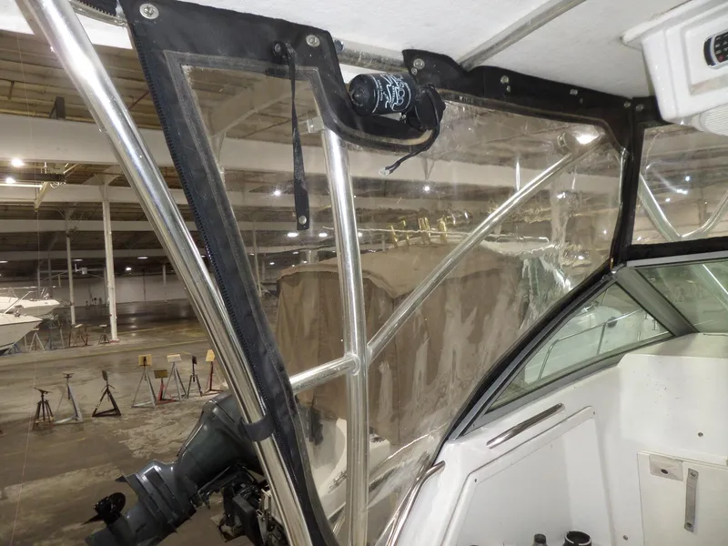 Slide: The Image of 1999 Sport-Craft 251 WA boat interior with clear enclosure and stainless steel frame. - 20