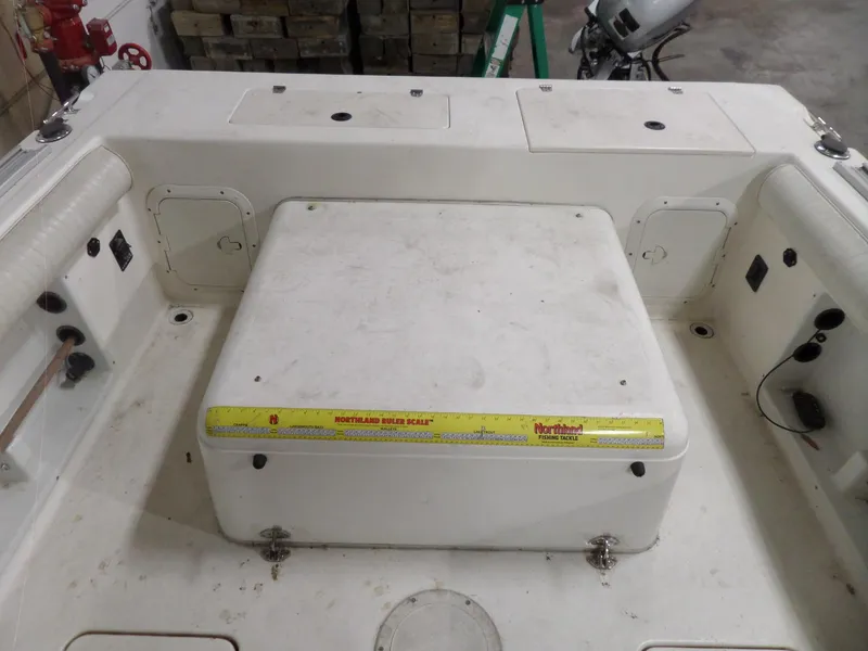 Slide: The Image of 1999 Sport-Craft 251 WA boat interior with storage compartments and measuring tape. - 26