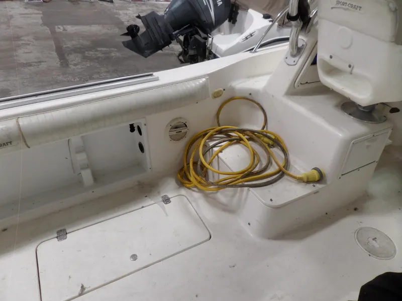Slide: The Image of 1999 Sport-Craft 251 WA boat interior with coiled yellow cable. - 28