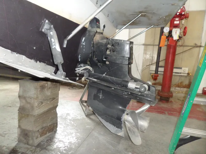 Slide: The Image of 1999 Sport-Craft 251 WA boat engine and propeller in maintenance setting. - 3