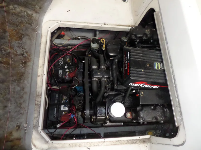 Slide: The Image of 1999 Sport-Craft 251 WA boat engine compartment with MerCruiser motor and wiring. - 30