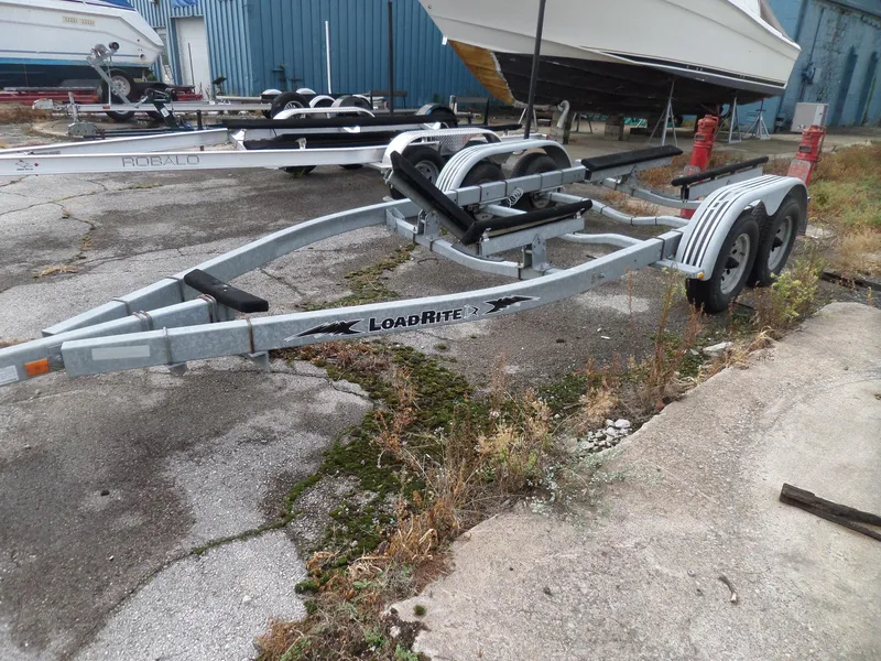 Slide: The Image of Boat trailer for 1999 Sport-Craft 251 WA, Load Rite brand, parked outdoors. - 31