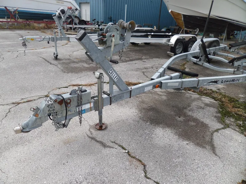 Slide: The Image of Boat trailer for 1999 Sport-Craft 251 WA, parked on concrete lot. - 32