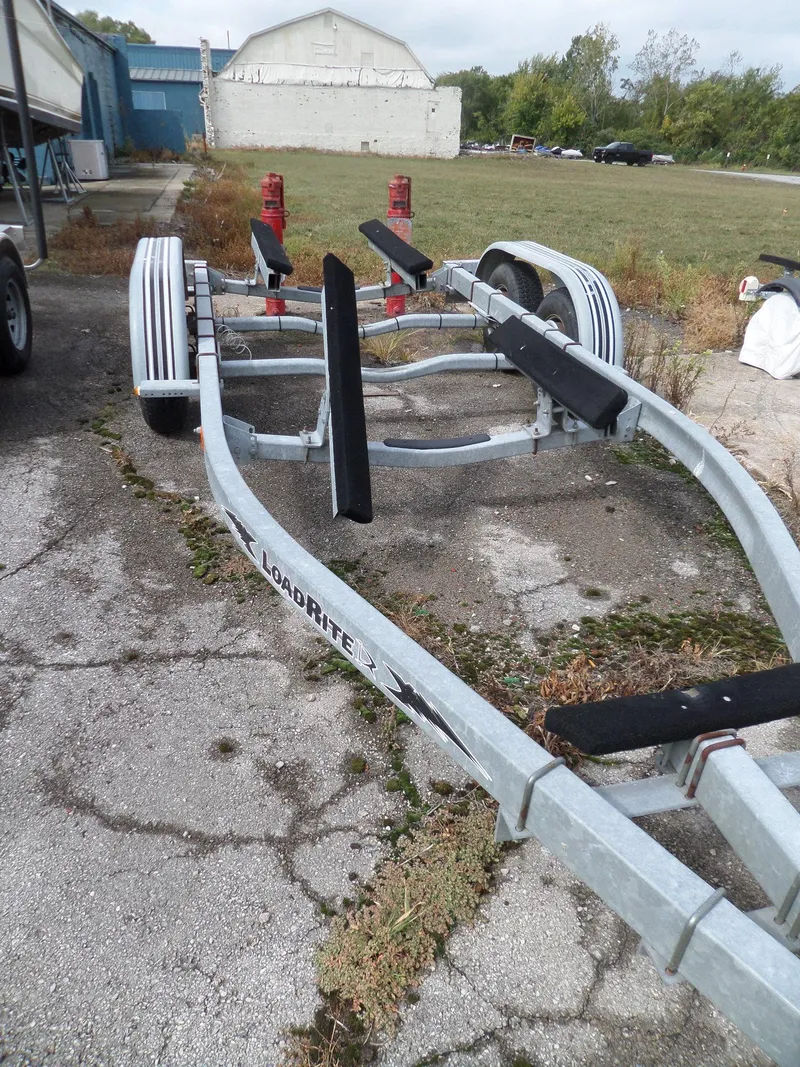 Slide: The Image of 1999 Sport-Craft 251 WA boat trailer on paved lot, ready for transport. - 35