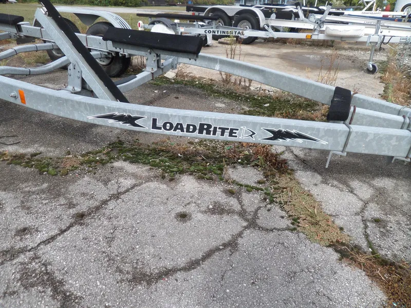 Slide: The Image of Load Rite boat trailer on cracked pavement, suitable for 1999 Sport-Craft 251 WA. - 36