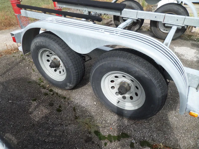 Slide: The Image of Dual axle trailer for 1999 Sport-Craft 251 WA boat on pavement. - 37