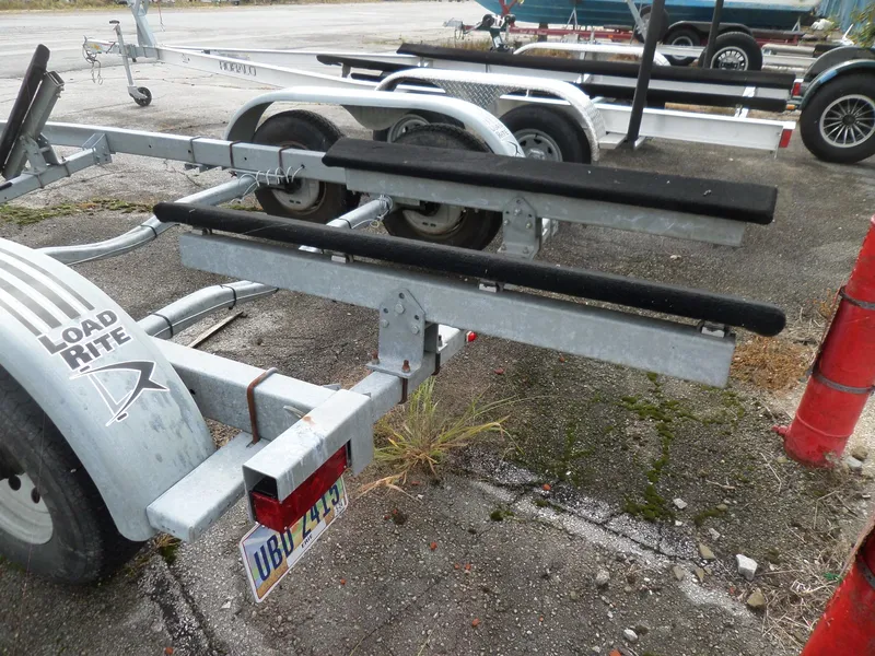 Slide: The Image of Boat trailer for 1999 Sport-Craft 251 WA, Load Rite brand, parked on concrete. - 40