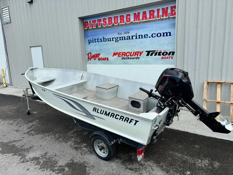 Slide: The Image of 2014 Alumacraft V14 boat with outboard motor at Pittsburg Marine dealership. - 3