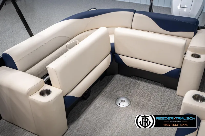Slide: The Image of 2025 Tahoe LTZ EL boat interior with beige and blue seating, cup holders, and carpeted flooring. - 25
