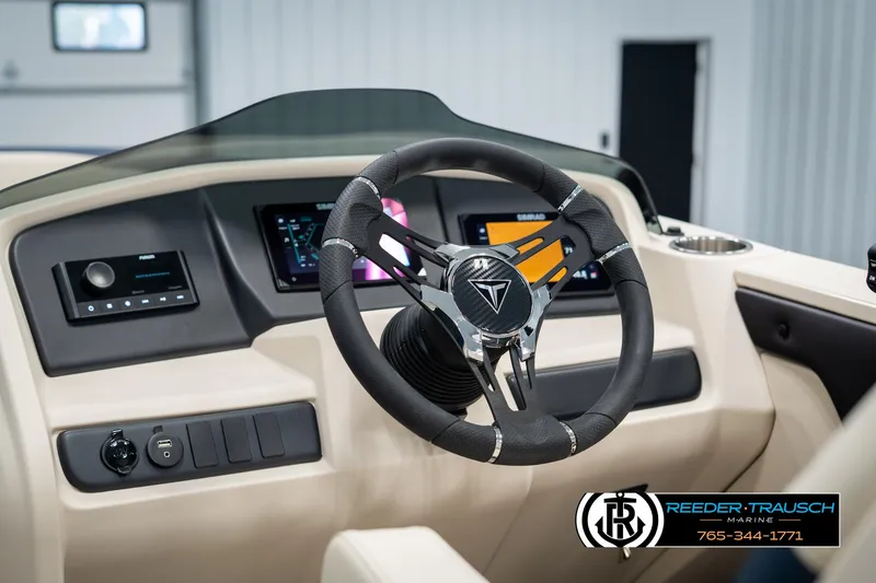 Slide: The Image of Steering wheel and dashboard of 2025 Tahoe LTZ EL boat, featuring modern controls. - 27